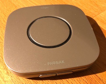 A transmitter with an omnidirectional microphone placed on a table.